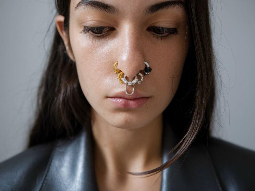 kobieta z różnymi kolczykami w nosie
